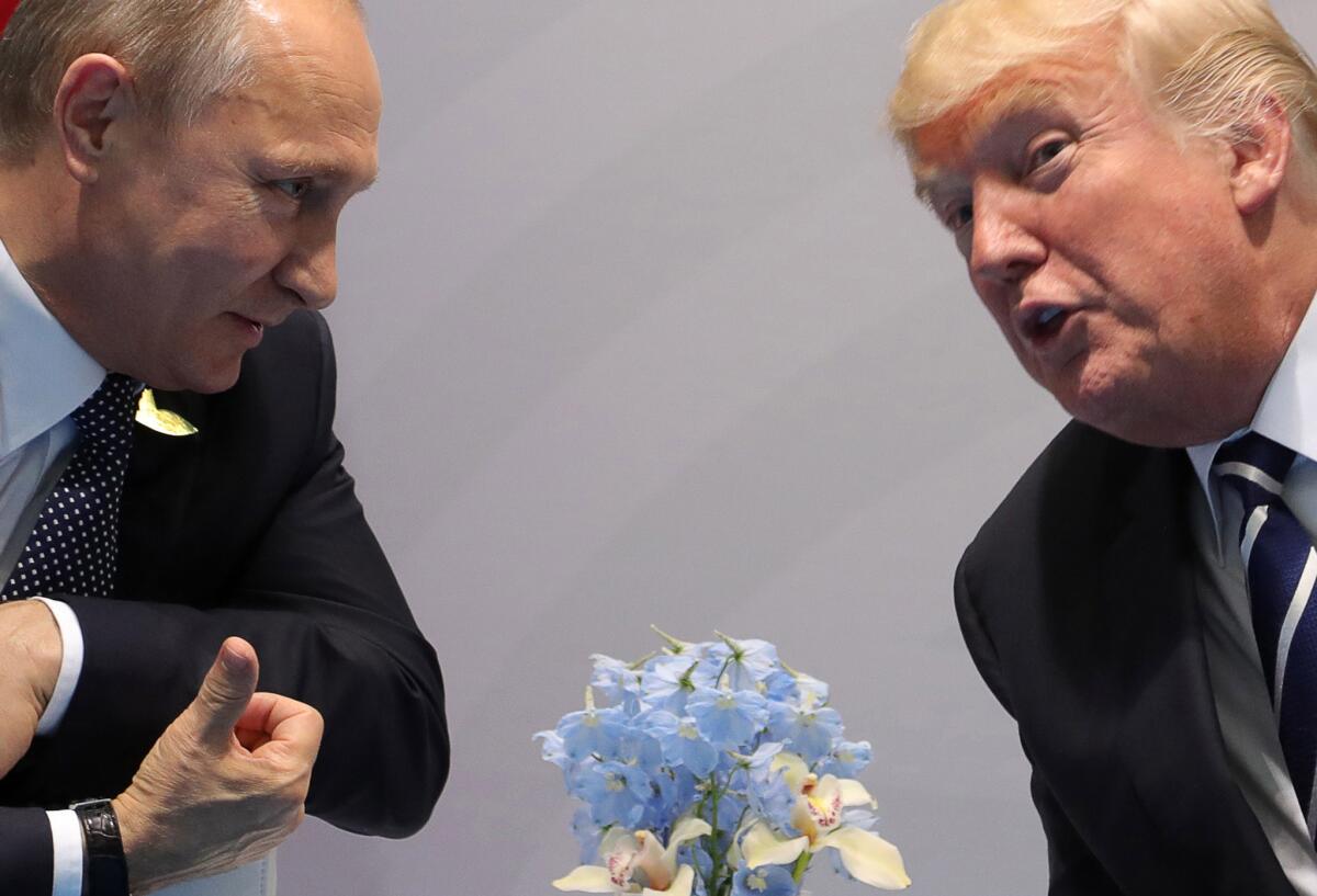 Russian President Vladimir Putin, left, and President Trump talk on the sidelines of the Group of 20 summit meeting in July in Hamburg, Germany. (Klimentyev Mikhail / Tass/ TNS)