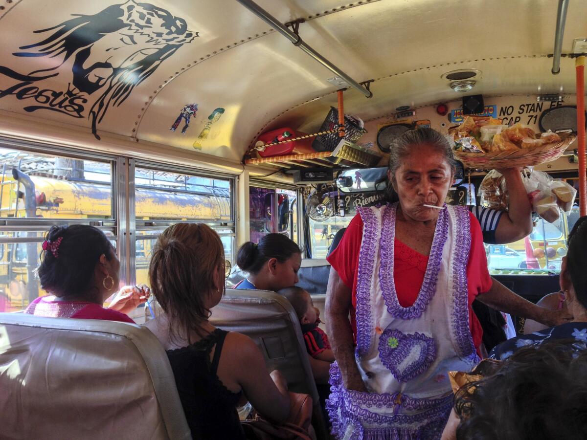 A vendor selling fried plantains and other treats squeezes through the aisle on one of the many chicken buses that Katie Quirk and her family rode during their stay in Granada, Nicaragua. (Katie Quirk)