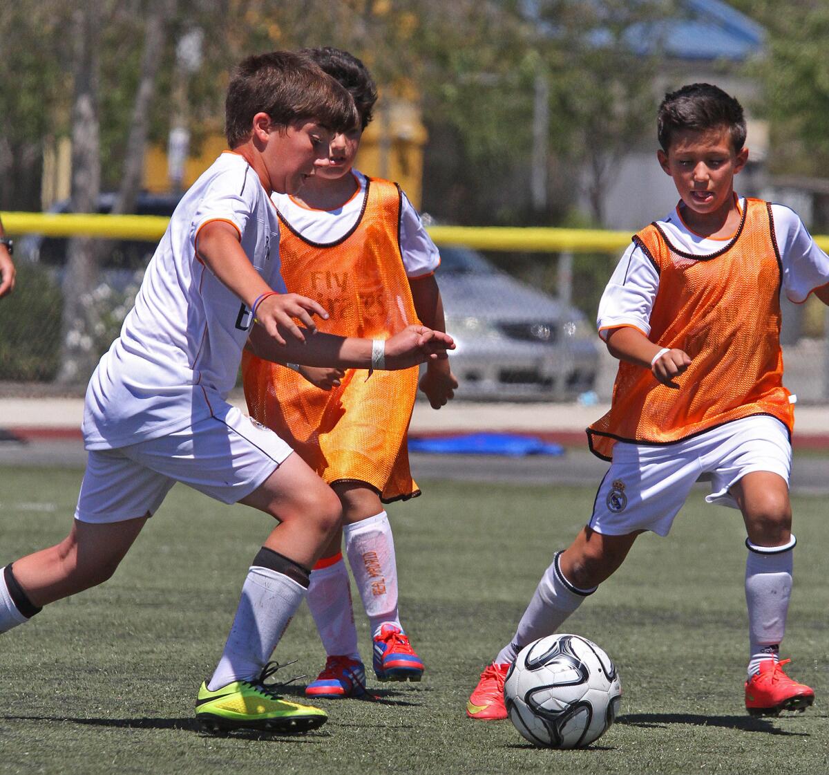 Campers run with the ball at The Real Madrid Foundation Campus Experience Soccer camps during a scrimmage with Team Casillas, the youngest soccer campers at the Glendale Sports Complex on Tuesday, July 22, 2014. These camps, for soccer players from 7-17, are new and starting out in Southern California, the first of which at the Glendale Sports Complex.