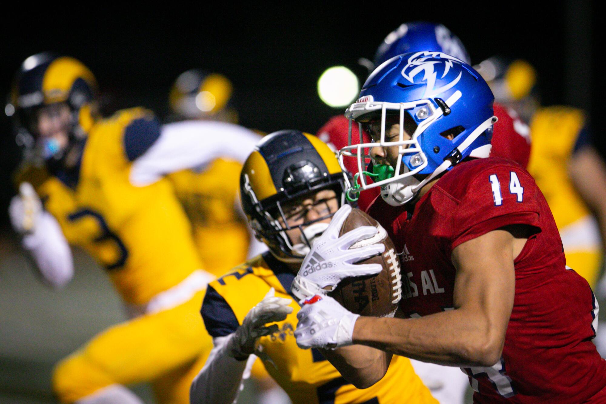 Los Alamitos cornerback Makai Lemon (14) intercepts a pass