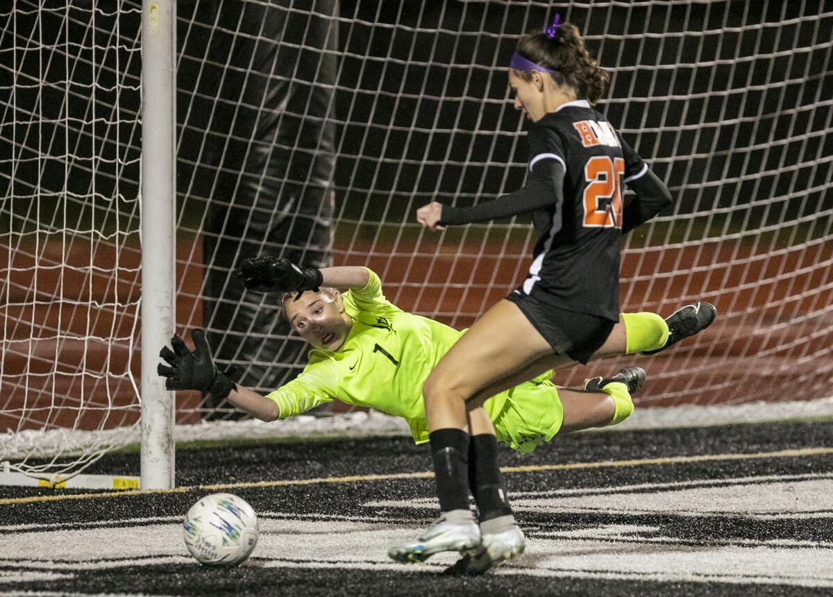 Los Alamitos' Avarie Gonzalez attempts to block a shot from Huntington Beach's Solana Van Enoo during a Surf League match.