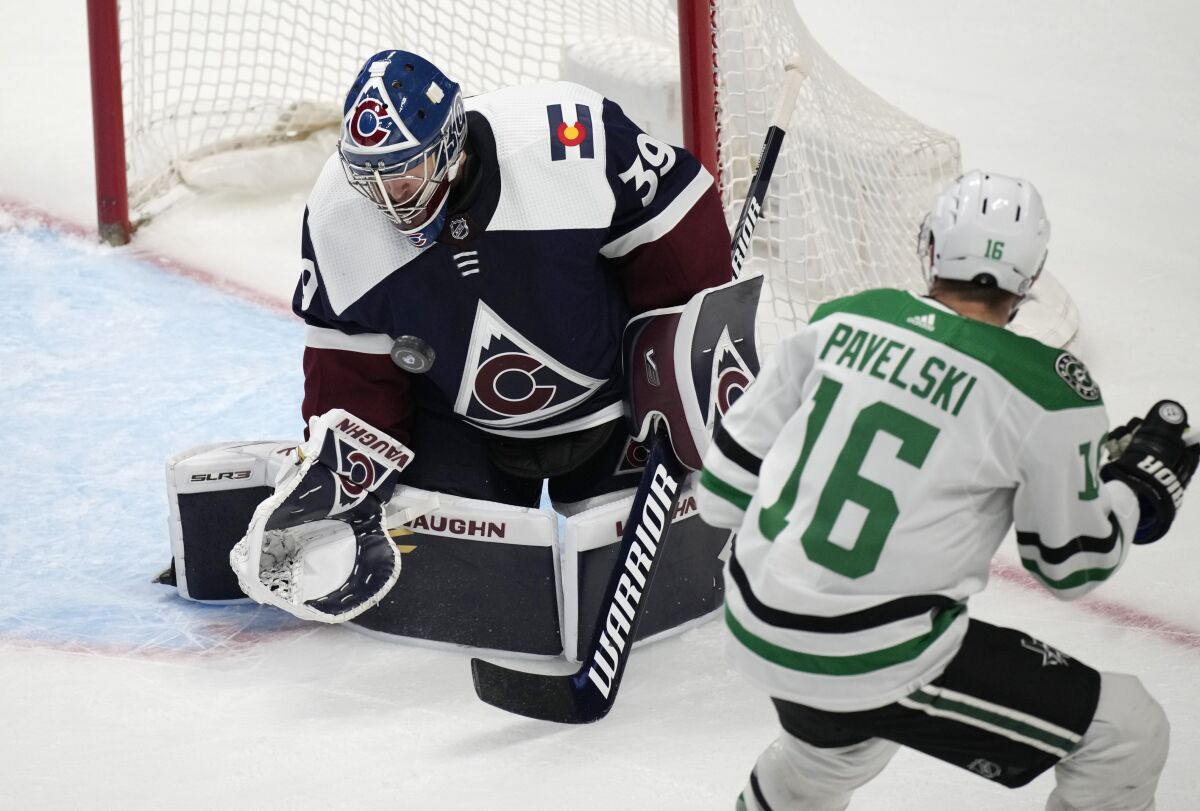 Colorado Avalanche goaltender Pavel Francouz, left, stops a shot by Dallas Stars center Joe Pavelski during the third period of an NHL hockey game Tuesday, Feb. 15, 2022, in Denver. The Stars won 4-1. (AP Photo/David Zalubowski)