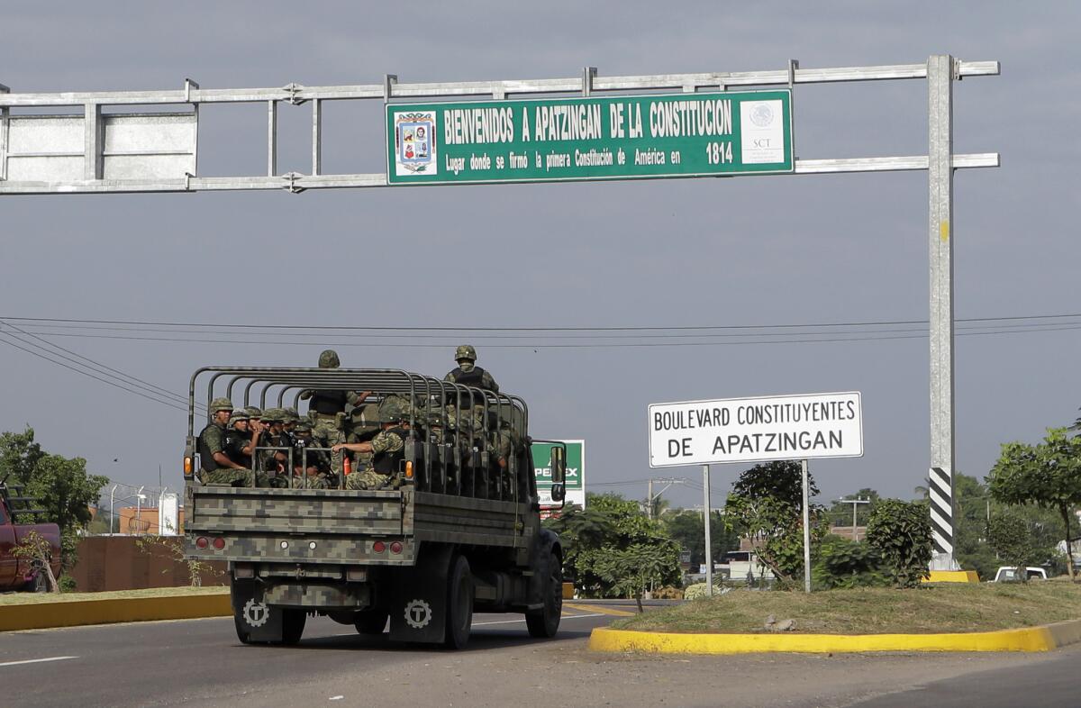An army convoy enters Apatzingan in Michoacan state, Mexico. The city is near Lazaro Cardenas, where Mexico's military has taken control of one of the nation's busiest seaports as part of its effort to bring drug cartel activity under control.