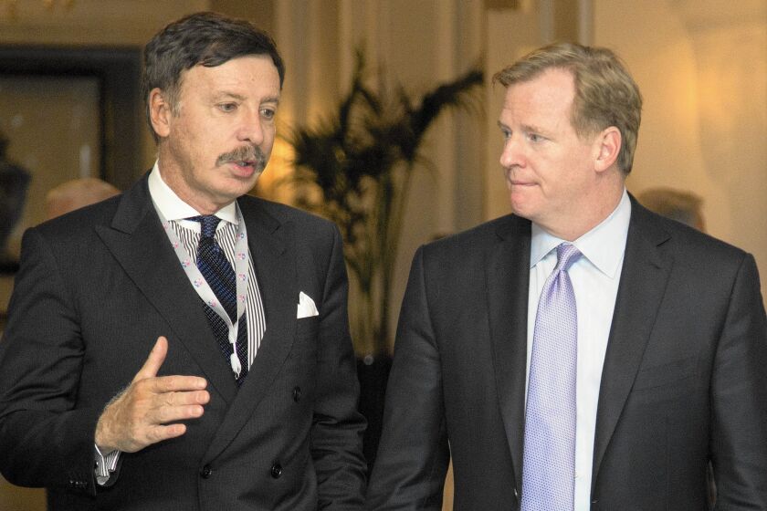 Stan Kroenke, left, owner of the St. Louis Rams, talks with NFL Commissioner Roger Goodell during a break in the 2013 NFL fall meeting in Washington.