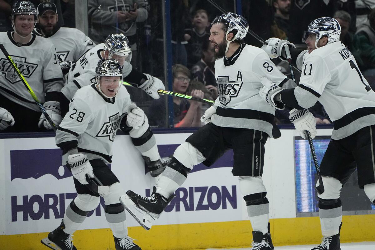 Drew Doughty (8) celebrates his winning goal with Jaret Anderson-Dolan (28) and Anze Kopitar.