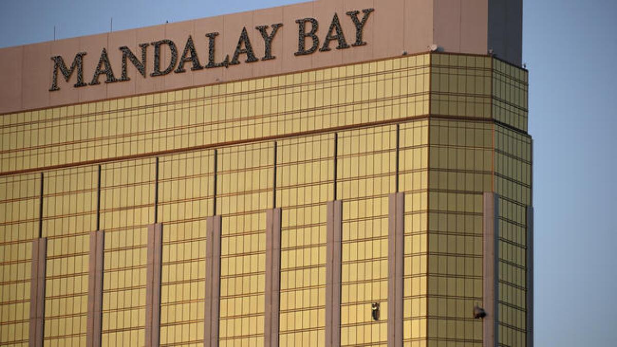 Drapes billow from broken windows Monday at the Mandalay Bay Resort and Casino on the Las Vegas Strip. Police say gunman Stephen Paddock targeted music festival-goers and was found dead in the room.