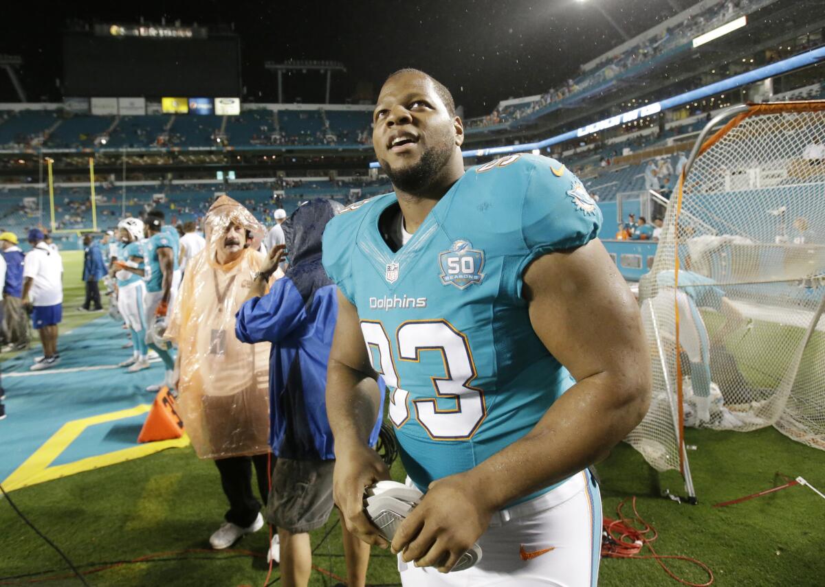 Miami Dolphins defensive tackle Ndamukong Suh (93) walks off the field at the end of an NFL preseason football game against the Atlanta Falcons, Saturday, Aug. 29, 2015 in Miami Gardens, Fla. The Dolphins defeated the Falcons 13-9.