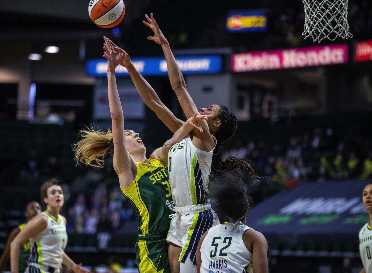 Seattle Storm's Breanna Stewart shoots as Dallas Wings forward Isabelle Harrison defends during a WNBA basketball game Friday, June 4, 2021, in Everett, Wash. (Dean Rutz/The Seattle Times via AP)