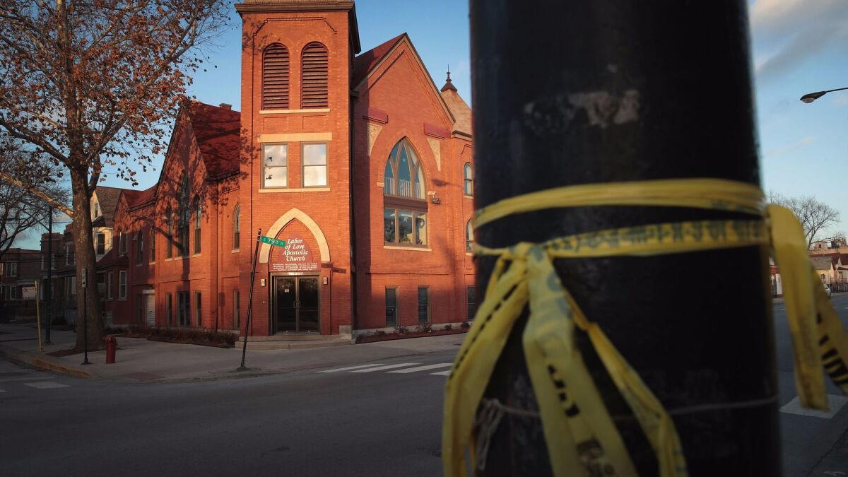 Crime scene tape is tied to a pole in Chicago across from the Labor of Love church, where a Christmas day shooting left Jamil Farley dead on Dec. 27, 2016.
