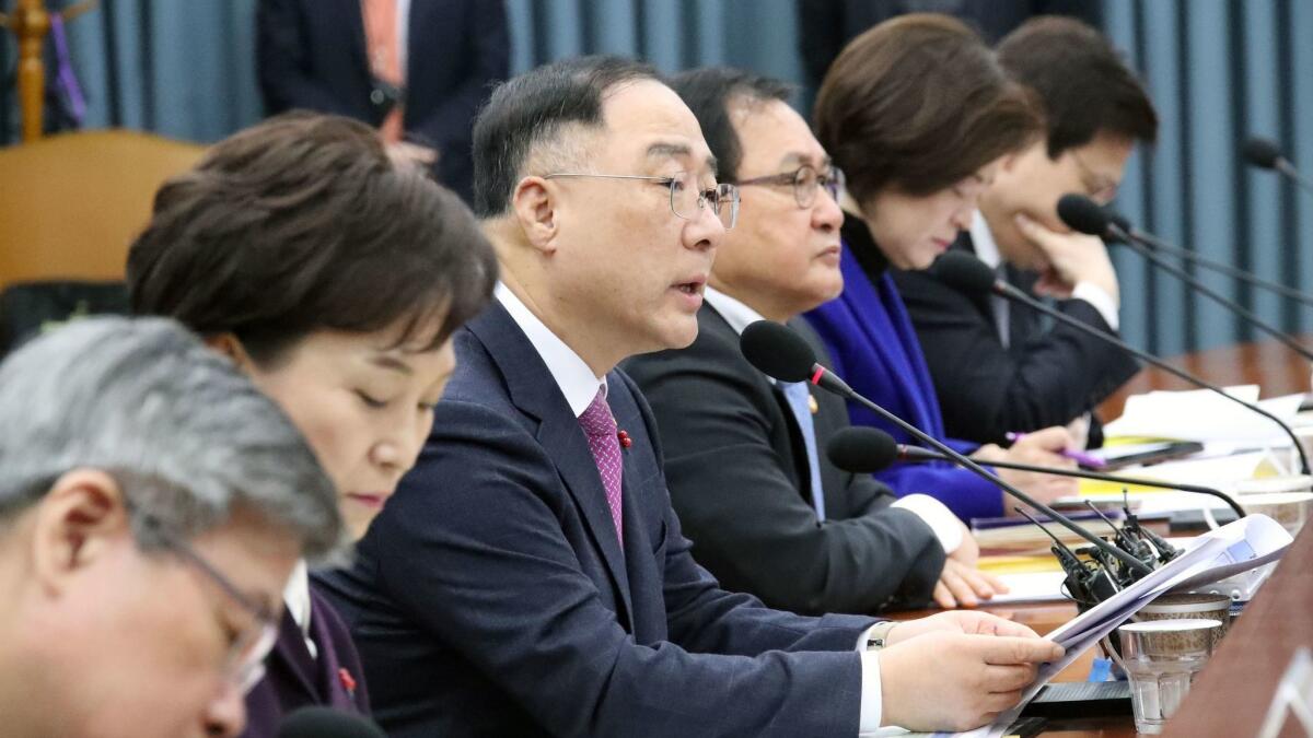 South Korean Finance Minister Hong Nam-ki, third from left, makes remarks at a meeting on reviving the economy at the government complex in Seoul on Jan. 9, 2019.