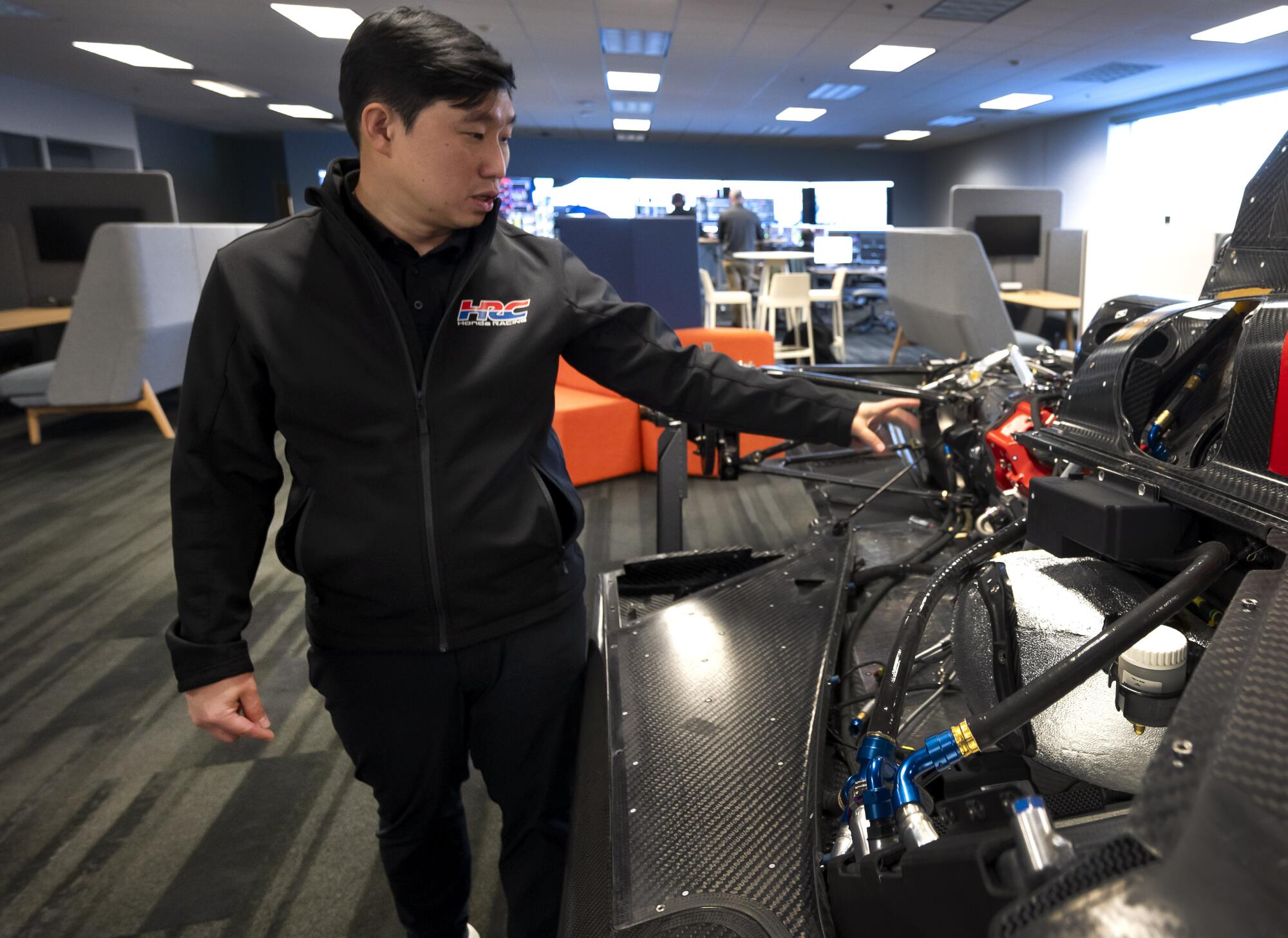Powertrain chief engineer Adi Susilo looks at a full-size mock up of an IMSA prototype at Honda Racing Corporation.