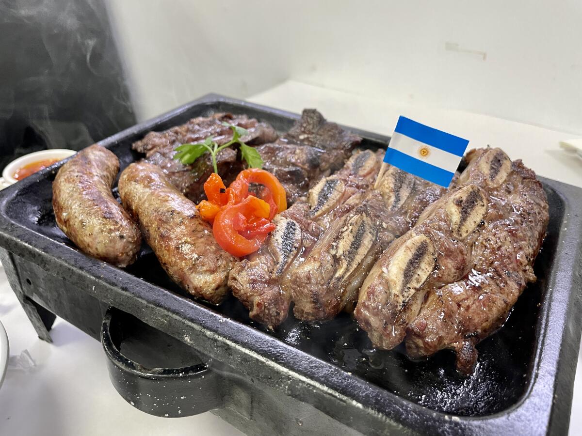 A tabletop grill covered with meat