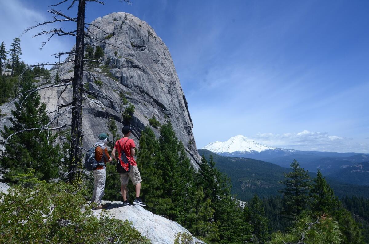 Hikers on the Crags Trail, Castle Crags State Park, Calif., look toward Mt. Shasta.