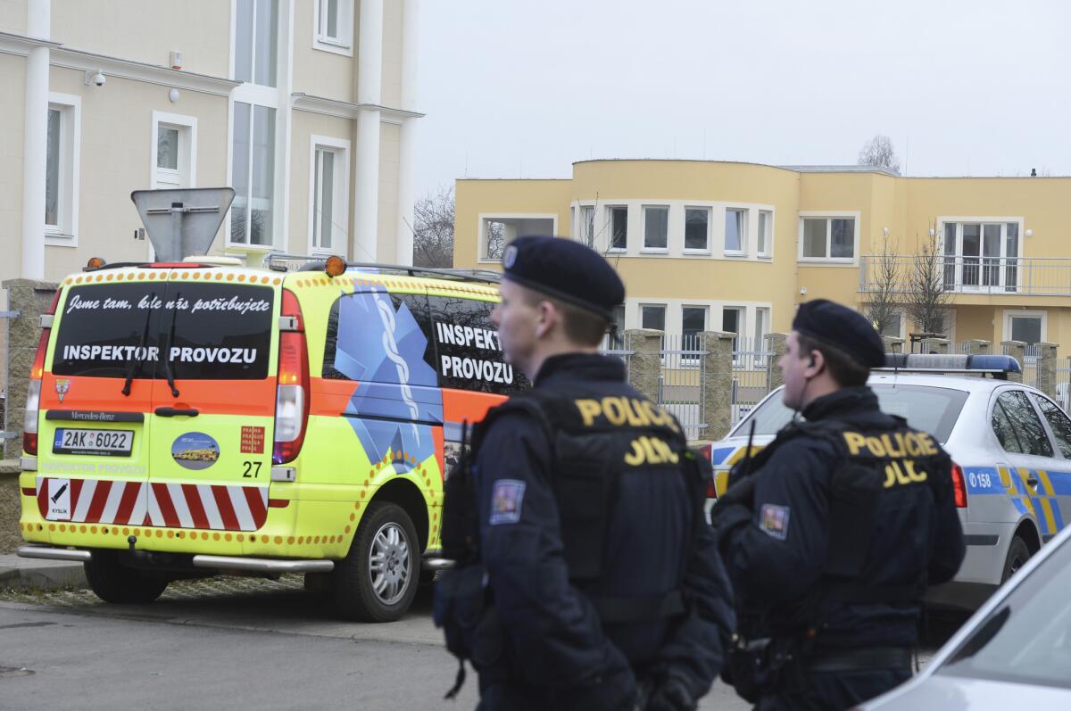 Czech police observe the situation near the Prague residence, right back, of Palestinian ambassador to the Czech Republic Jamal Jamal, who was mortally wounded in an explosion Wednesday.
