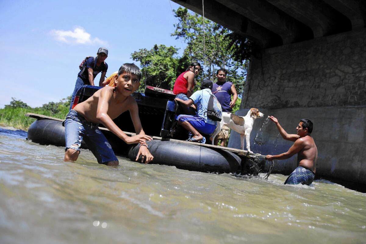 A raft carrying immigrants bound for the U.S. crosses the Suchiate River from Guatemala into Mexico.
