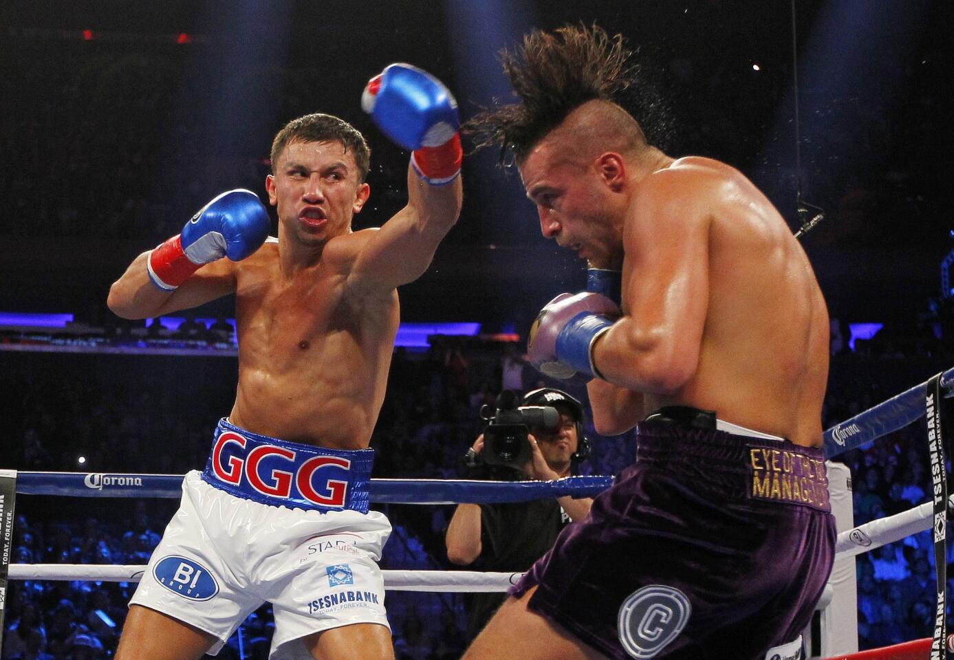 Gennady Golovkin, left, hits David Lemieux in the second round of a middleweight title fight at Madison Square Garden in New York.
