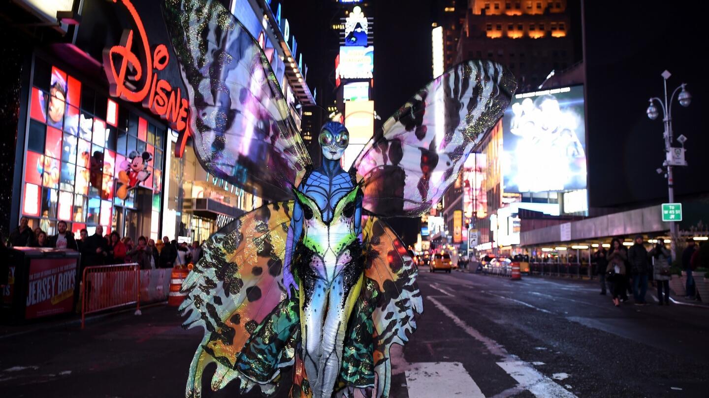 Heidi Klum gives Times Square visitors a sneak peek of her Halloween costume before hosting her annual party.