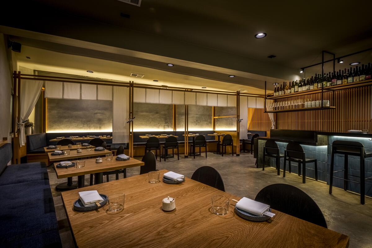 A moody photo of the interior dining room of n/soto, its design inspired by Japanese izakayas.