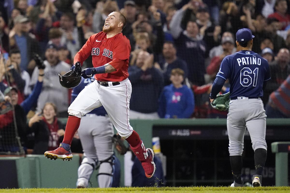 Boston Red Sox Christian Vazquez celebrates as he approaches home plate after hitting a two-run walk-off home run during the thirteenth inning against the Tampa Bay Rays during Game 3 of a baseball American League Division Series, Sunday, Oct. 10, 2021, in Boston. (AP Photo/Charles Krupa)