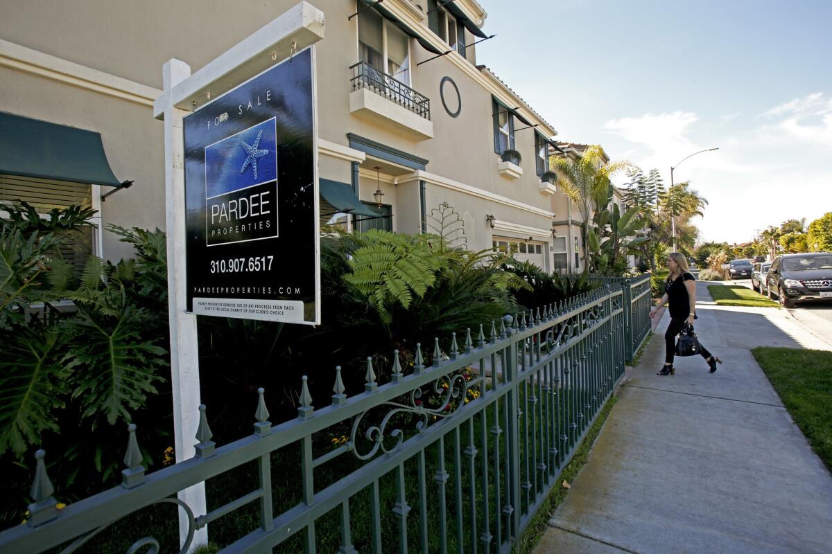 An open house this month in Venice. New data Tuesday showed that home prices dipped slightly at the start of 2014.