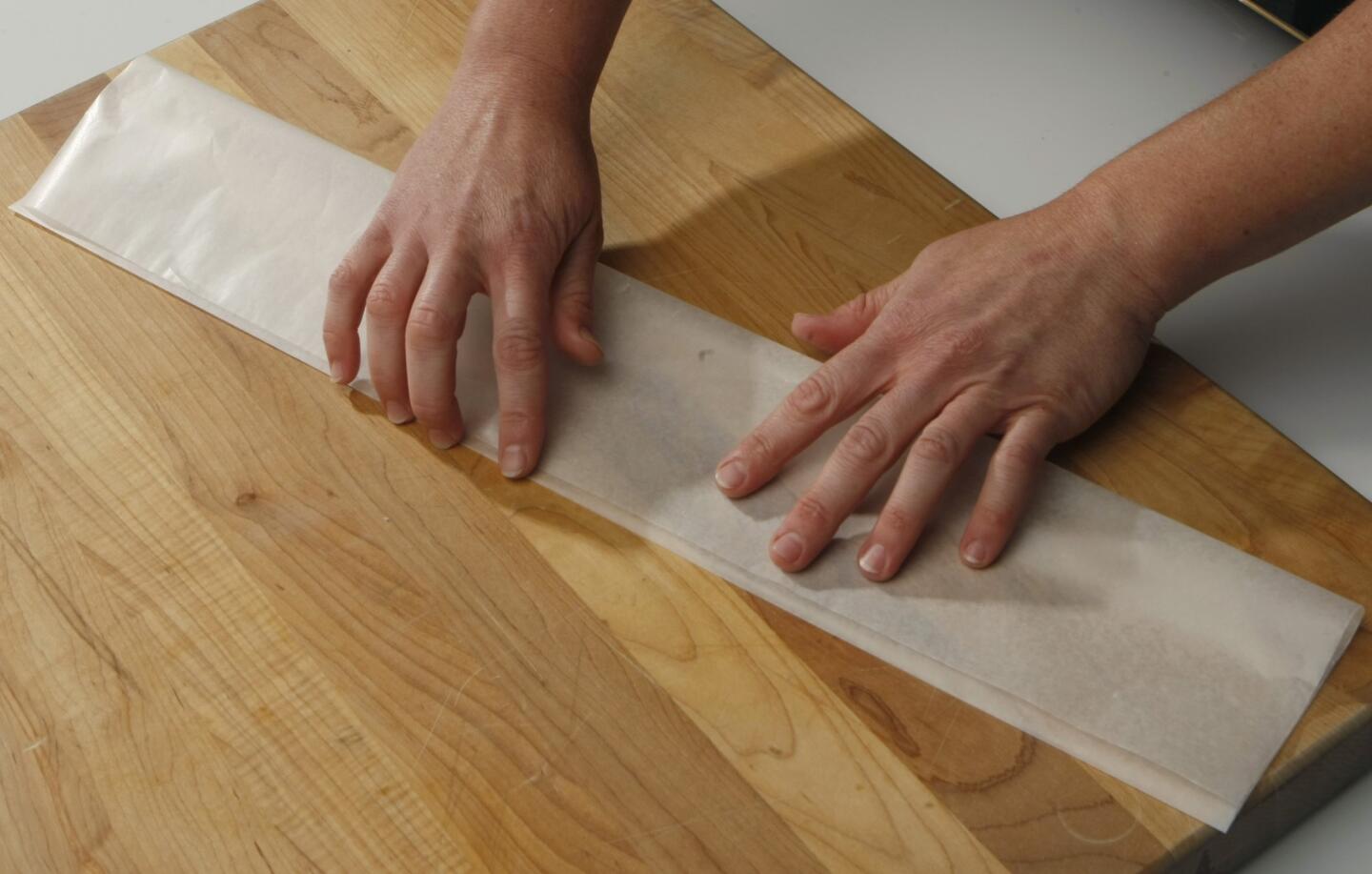 Fold a sheet of waxed paper into thirds deep enough to hold the souffle.