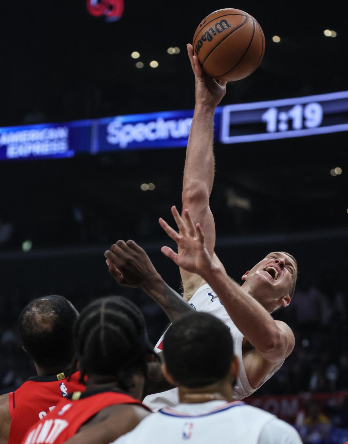 Clippers center Mason Plumlee elevates above Rockets defenders for a close-range shot Sunday.