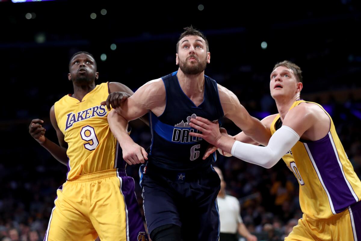 The Lakers' Luol Deng, left, and Timofey Mozgov guard Dallas' Andrew Bogut on Nov. 8.
