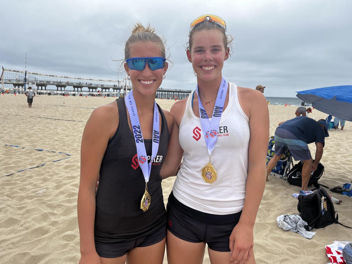 Danielle Sparks, left, and Haylee LaFontaine celebrate after winning the AAU U16 beach volleyball title.