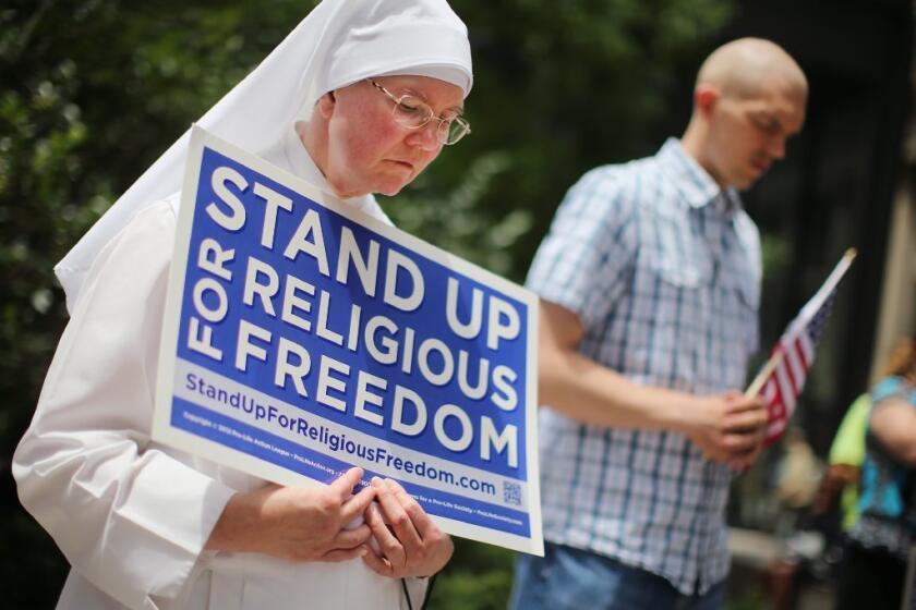 A supporter of the Supreme Court's Hobby Lobby ruling is seen attending a demonstration in Chicago on June 30.