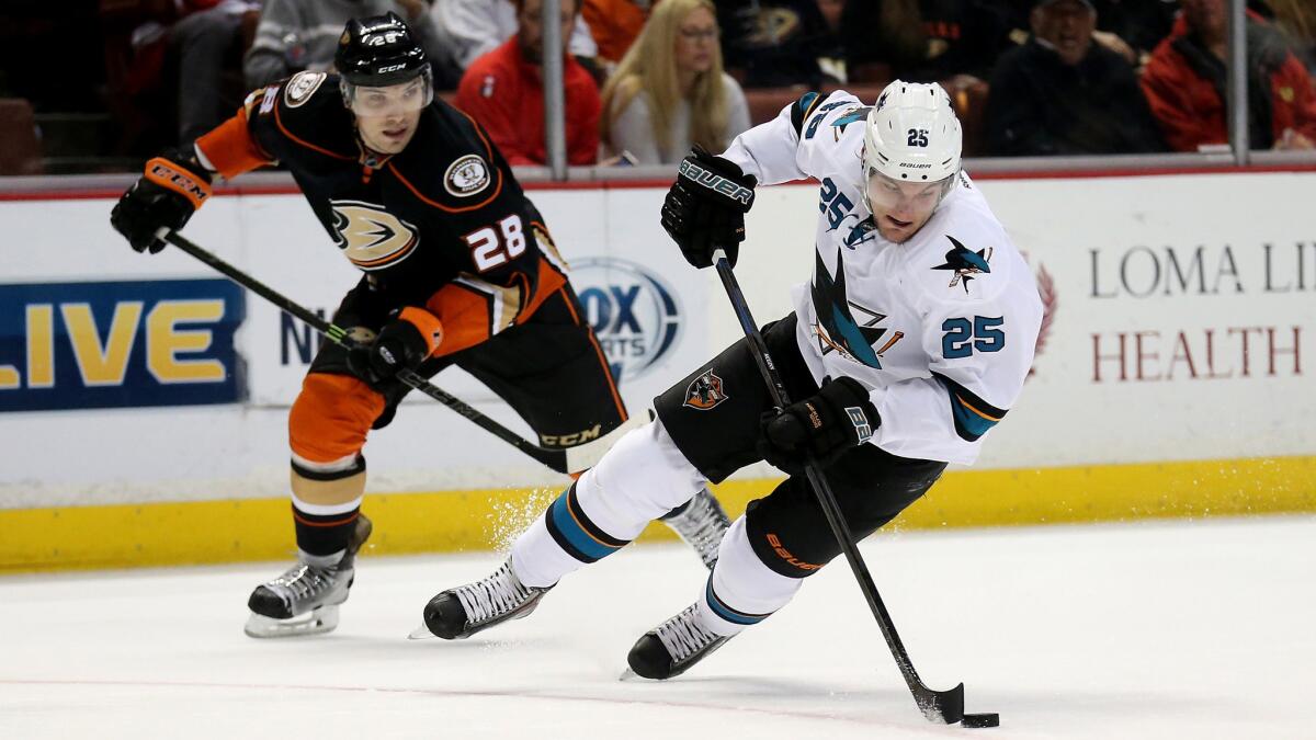 San Jose Sharks forward Tye McGinn, right, controls the puck ahead of Ducks defenseman Mark Fistric during the Ducks' 3-2 overtime win at Honda Center on Monday.