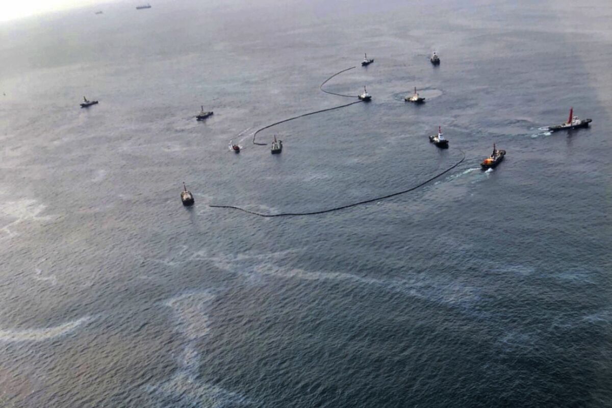 In this photo released by the Royal Thai Navy, an aerial view from a navy plane shows cleanup efforts of the latest oil spill off the coast of Rayong, eastern Thailand, Friday, Feb. 11, 2022. Thai authorities scrambled Friday to contain the country's second oil spill in less than three weeks in the Gulf of Thailand off the eastern province of Rayong, with an estimated 5,000 liters believed to have leaked. On Jan. 25, at least 20,000 liters spilled into the sea.(Royal Thai Navy via AP)