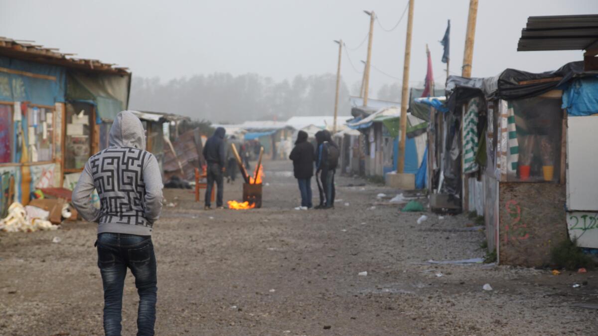 A young man walks through the camp early Sunday morning.