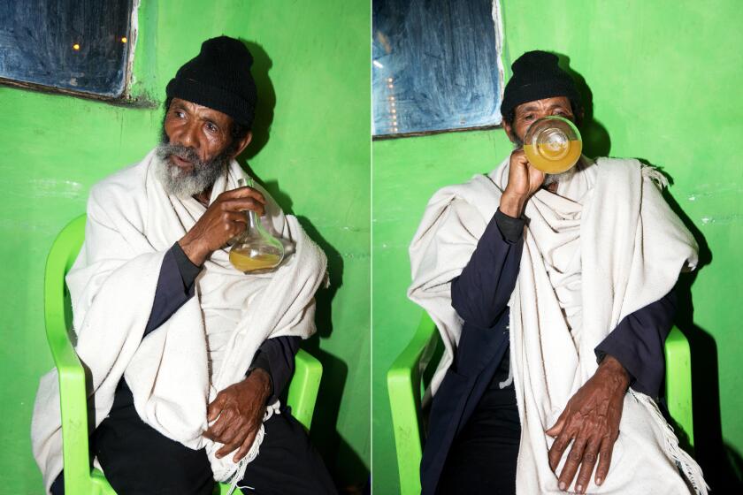 LALIBELA, ETHIOPIA – SEPTEMBER 2, 2019. A drinker at Berkay Tej Bet, a bar in Lailibela, Ethiopia that specializes in honey wine, on September 2, 2019.
