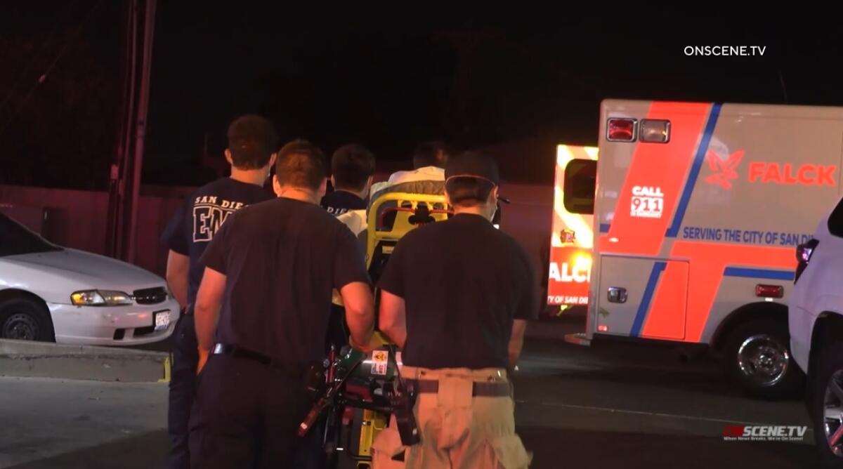 Paramedics wheel a stabbing victim to an ambulance Friday night in San Diego's El Cerrito neighborhood.