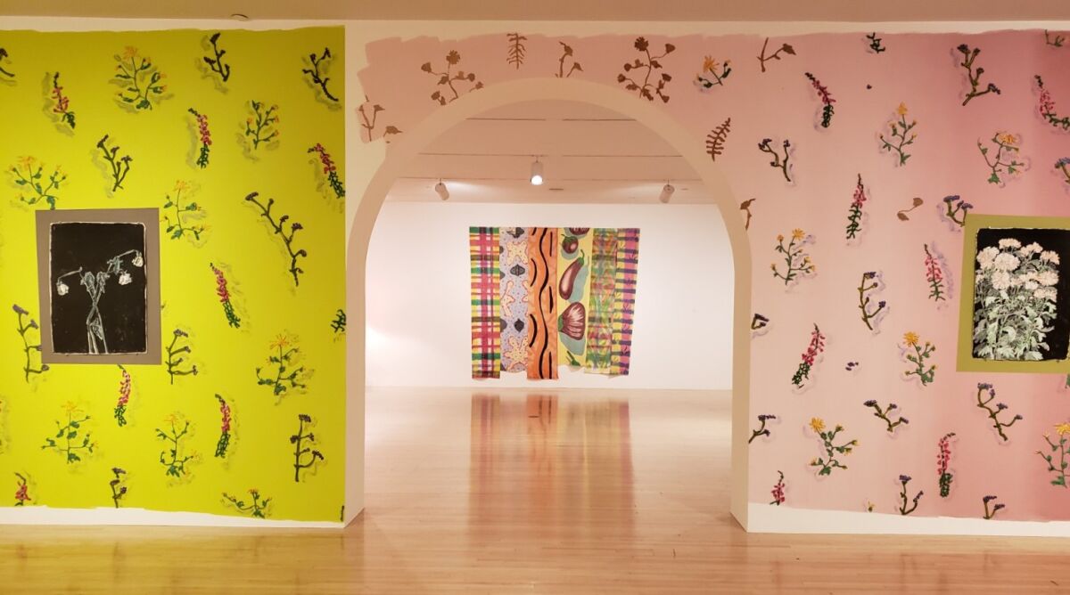 Cynthia Carlson's installation of painted "wallpaper" frames a view of a painted cotton banner by Kim MacConnel in "With Pleasure"