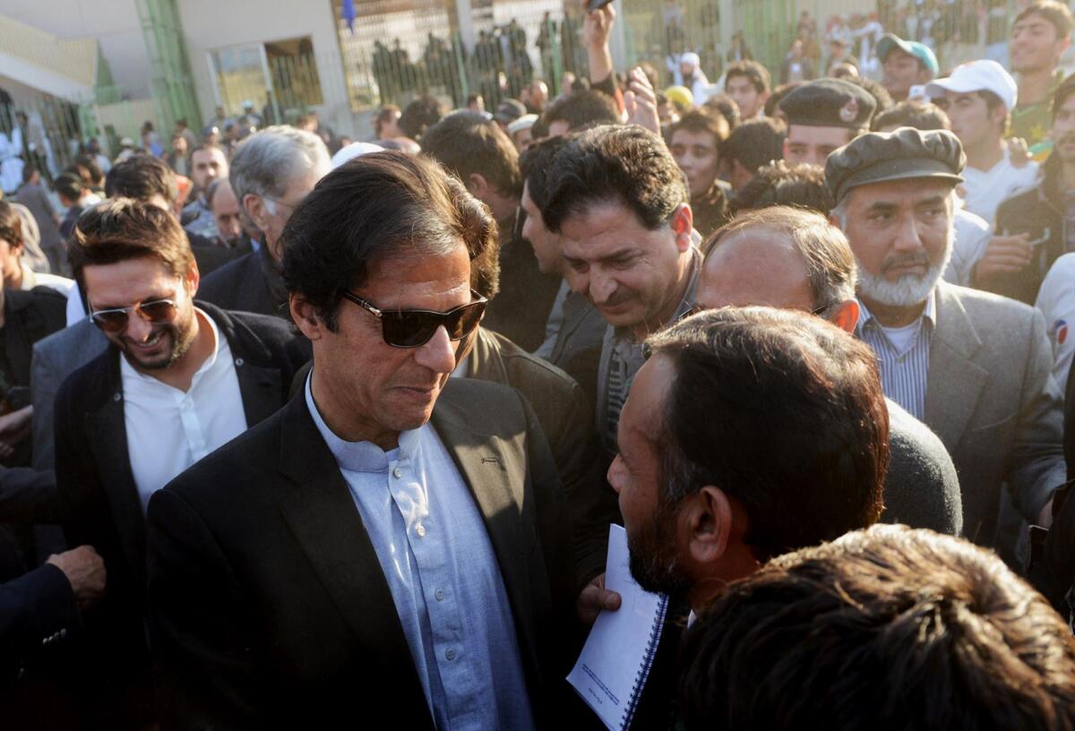 Former Pakistan cricket player-turned-politician Imran Khan, center, was nominated by the Pakistani Taliban to a negotiating team to enter talks with the government, but he said the Islamist militant group should choose "its own people" as representatives.