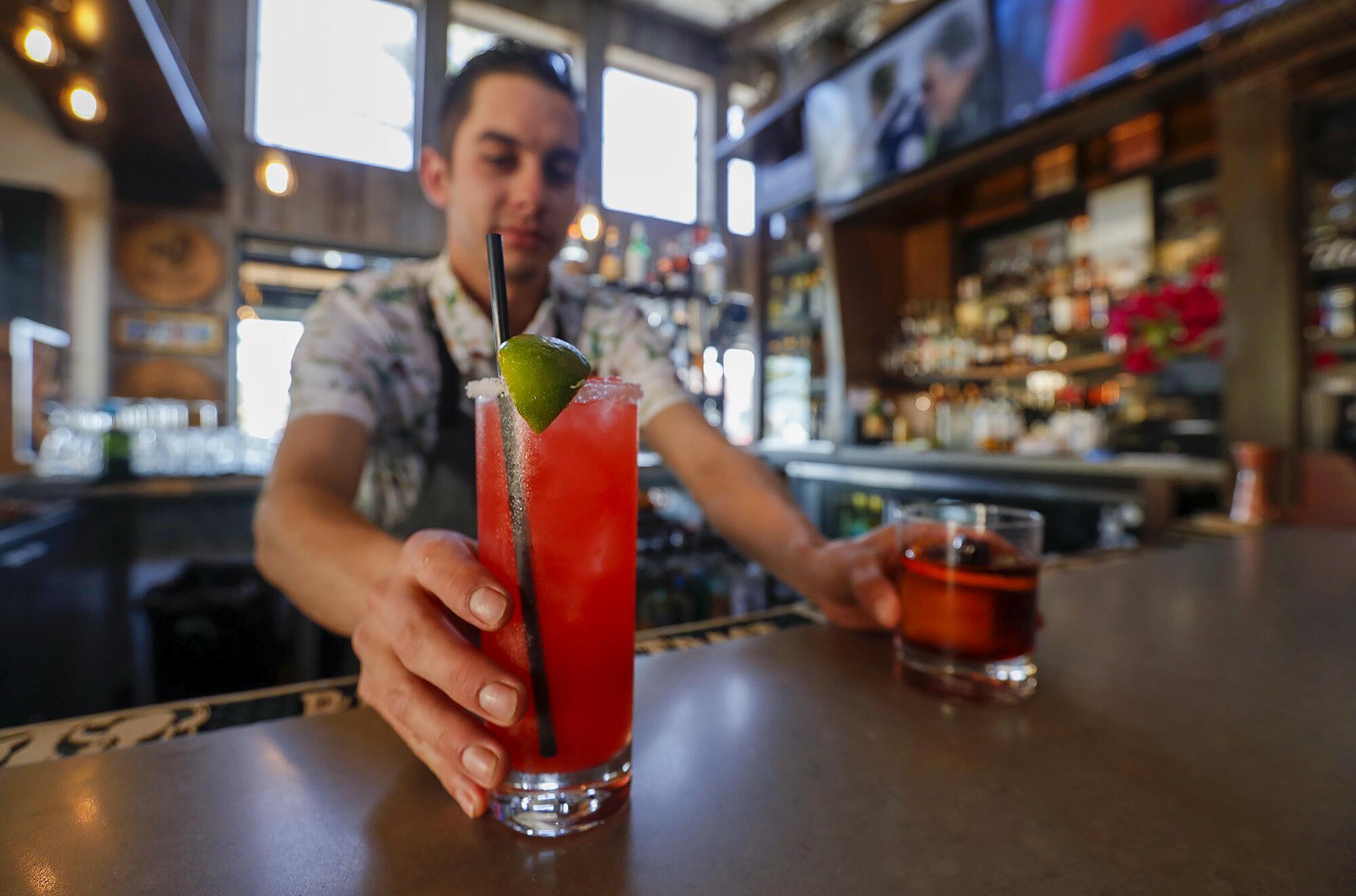 Bartender Nate Murguia serves a seasonal margarita and a Craft House old fashioned at the Craft House in Dana Point.