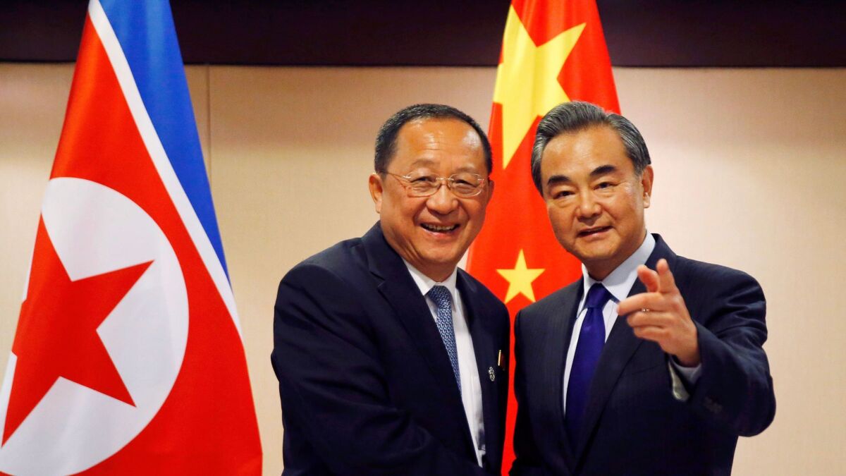 North Korean Foreign Minister Ri Yong Ho, left, with Chinese counterpart Wang Yi in Manila on Aug. 6, 2017, before the start of their meeting.