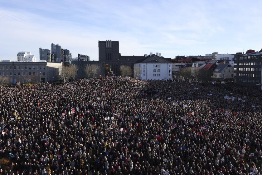 People across Iceland gather during the women's strike in Reykjavik, Iceland, Tuesday, Oct. 24, 2023. Iceland's prime minister and women across the island nation are on strike to push for an end to unequal pay and gender-based violence. (AP Photo/Arni Torfason)