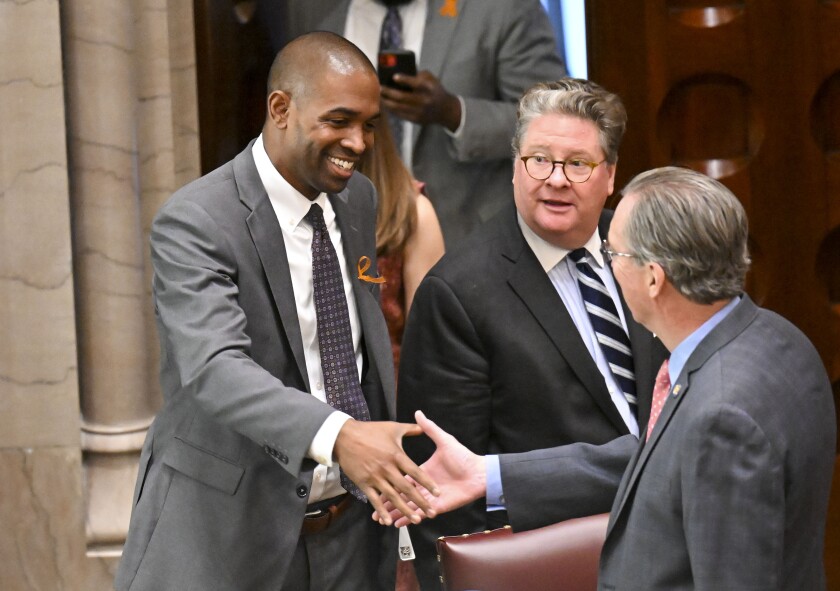 New York Lt. Gov. Antonio Delgado ,left, greets legislators before presiding over the Senate during a special legislative session to consider new firearms regulations for concealed-carry permits in the Senate Chamber at the state Capitol Thursday, June 30, 2022, in Albany, N.Y. (AP Photo/Hans Pennink)