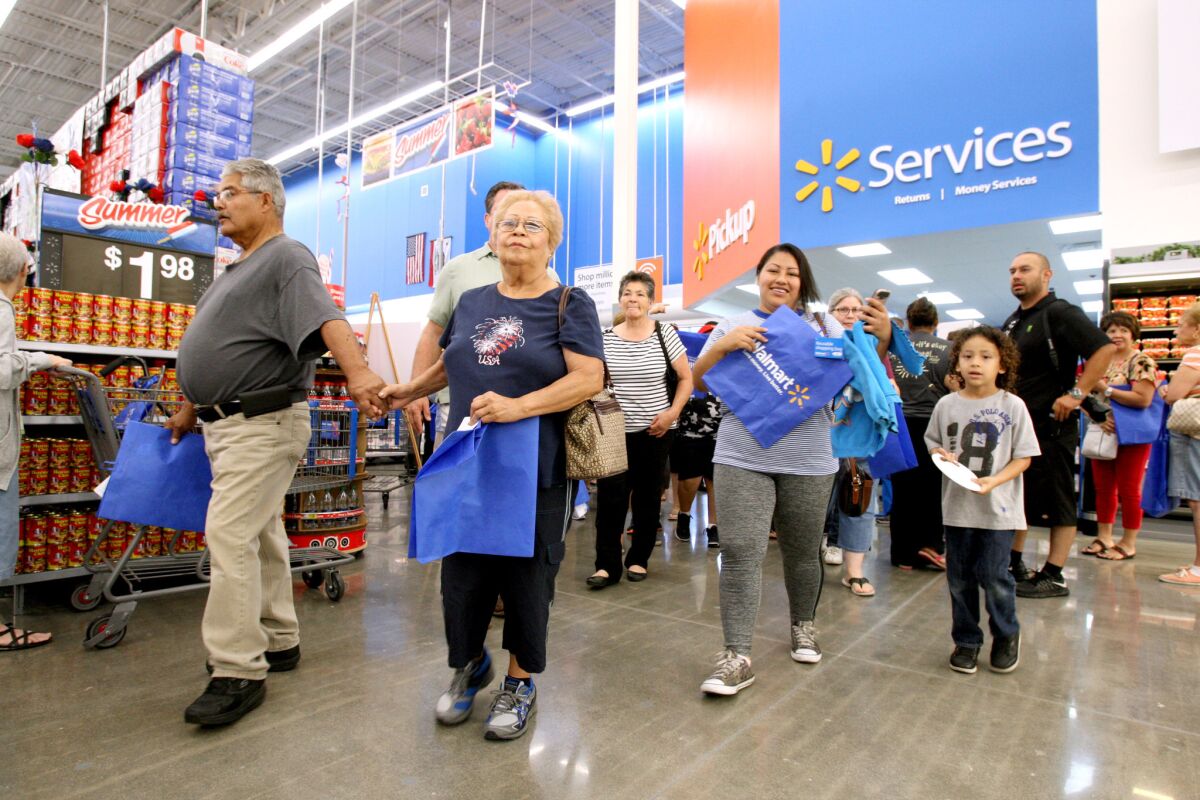 Walmart shoppers rush into the new superstore on N. Victory Place in Burbank for the location's grand opening on Wednesday, June 22, 2016.