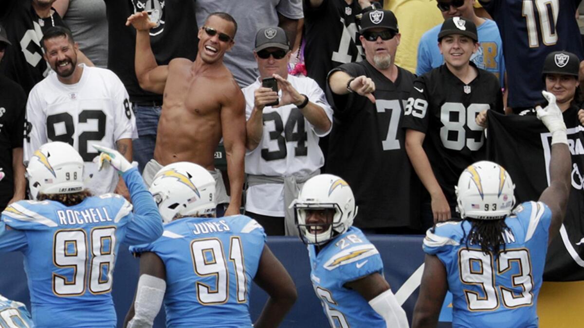 Chargers defensive unit faces off against a section full of Raiders fans after linebacker Melvin Ingram intercepted a Derek Carr pass in the end zone, stopping a third quarter Raiders' drive at StubHub Center.