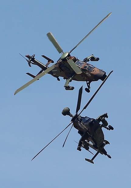 French, top, and German Tiger helicopters perform their demonstration flight during the first day of the 50th International Paris Air Show at Le Bourget airport.