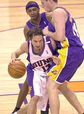 Phoenix Suns' Steve Nash works his way through Los Angeles Lakers' Stanislav Medvedenko, right, and Tierre Brown during the first quarter.