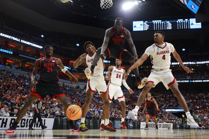 Louisville, KY - March 24: San Diego State's Nathan Mensah, left, and Aguek Arop battle for a rebound against Alabama in a Sweet 16 game in the NCAA Tournament on Friday, March 24, 2023 in in Louisville, KY. (K.C. Alfred / The San Diego Union-Tribune)