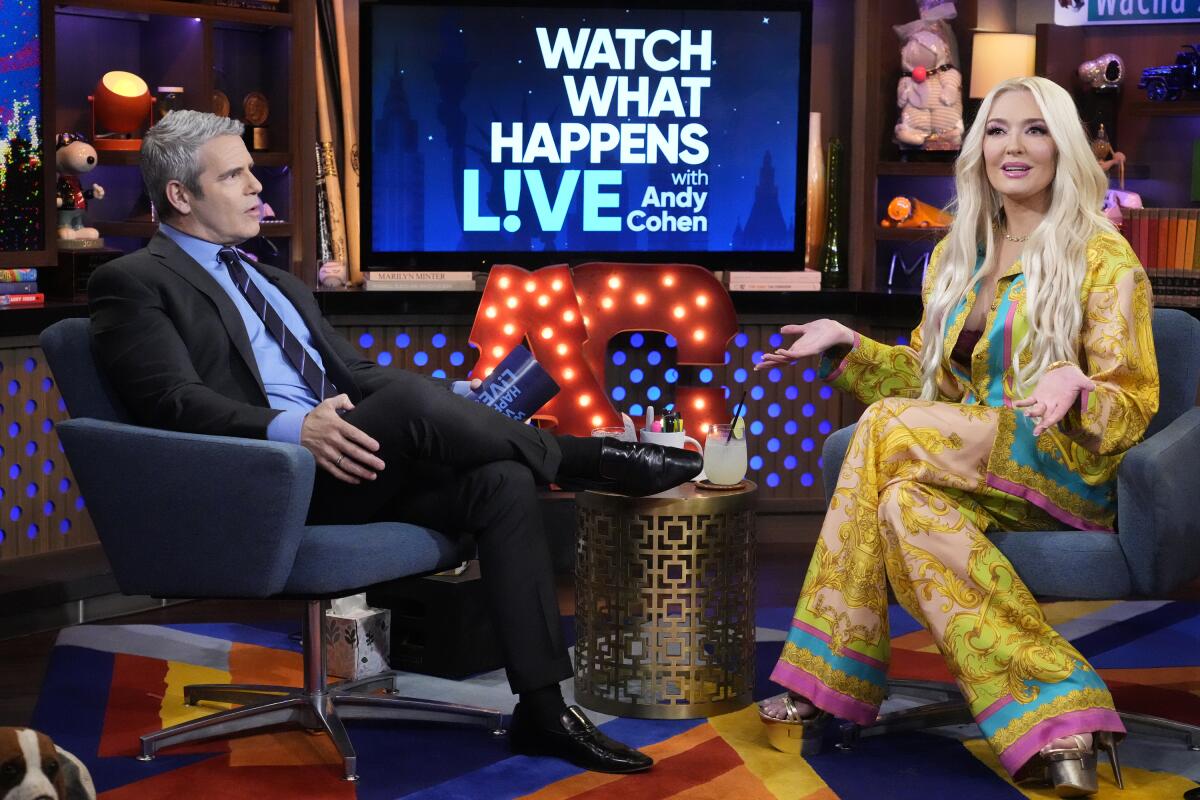 A man and a woman talk on a TV program.