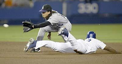 Shortstop Royce Clayton can't stop Dodger Adrian Beltre as he steals second base during the botton of the sixth inning.