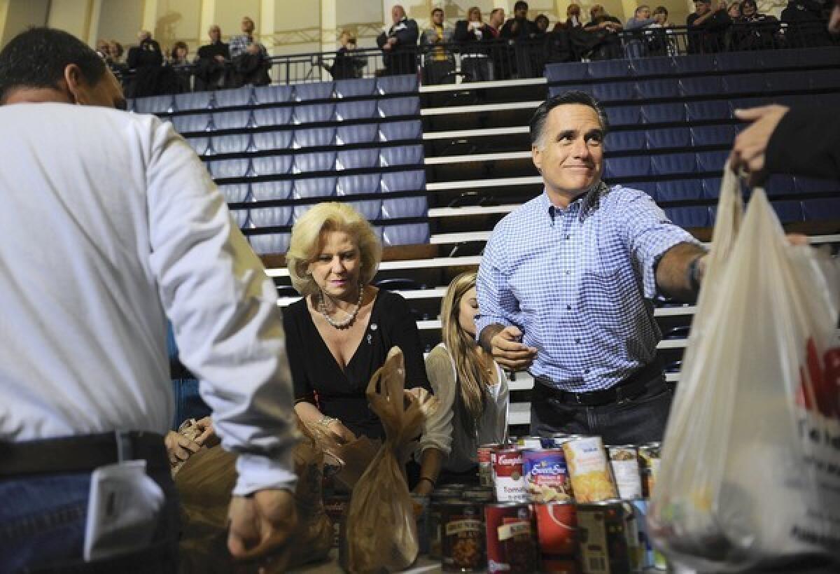Mitt Romney, originally in Kettering, Ohio, to campaign, helps collect and pack donated goods for victims of the storm.