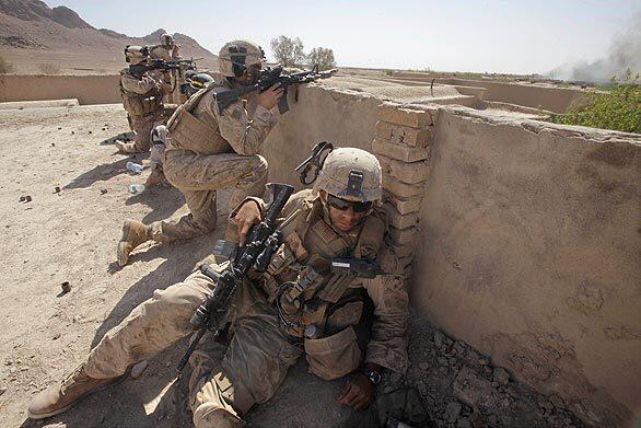 Marines take a position on a rooftop while fighting the Taliban in Dahaneh as part of Operation Eastern Resolve 2 in Helmand on Wednesday.