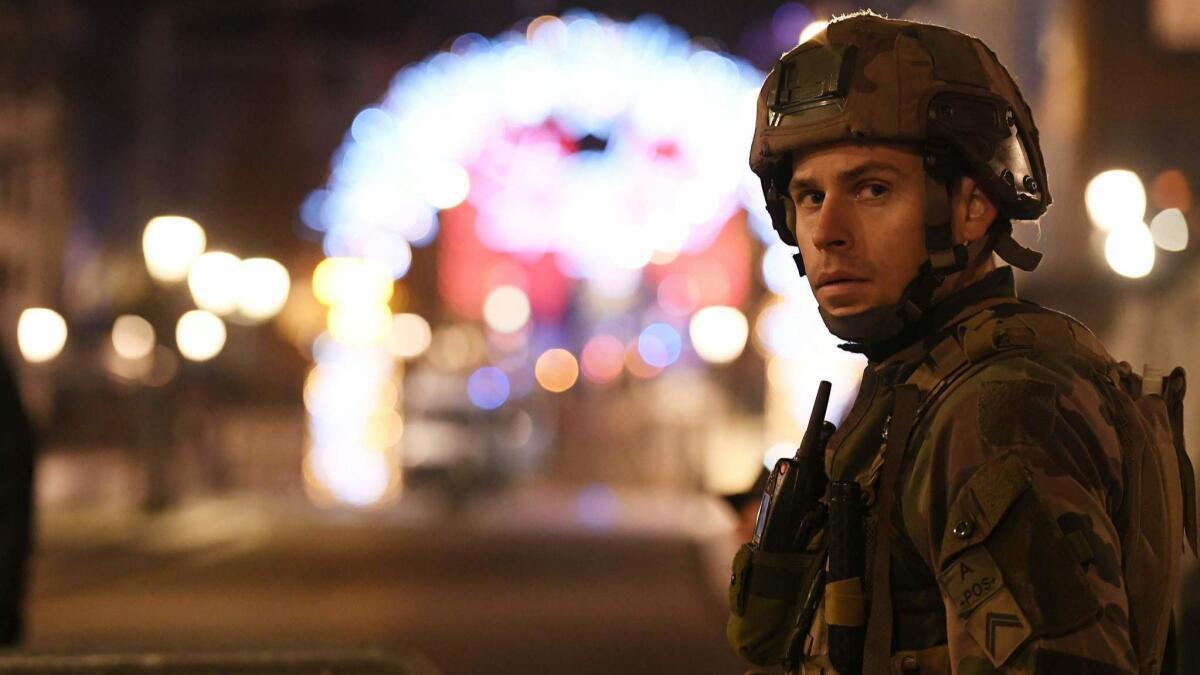 Military personnel are deployed near the Christmas market in Strasbourg, France, after a deadly shooting.